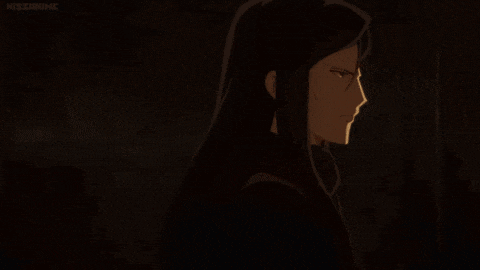 a man and a woman are standing next to each other in a dark room .