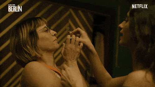 a netflix ad shows a woman in an orange tank top getting a shot