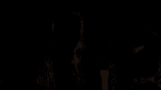 a woman with long brown hair is standing in front of a mirror with a green ribbon in her hair .