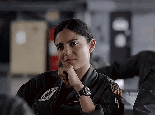 a woman in a military uniform has a patch on her arm that says first