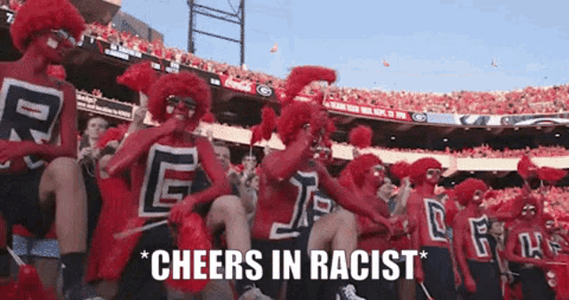 a group of cheerleaders are sitting in a stadium with the words cheers in racist