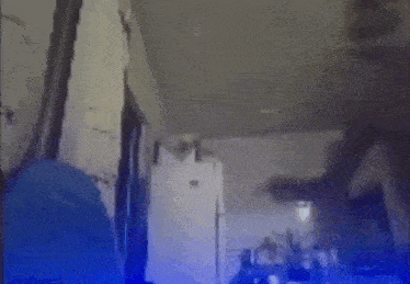 a blurry picture of a kitchen with a refrigerator and a ceiling fan