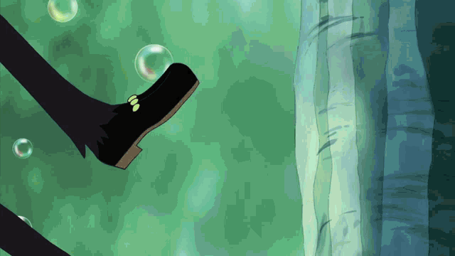 a person 's foot is kicking a soap bubble in the water