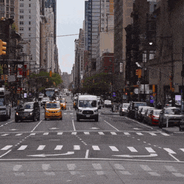 a busy city street with a sign that says " taxi " on it