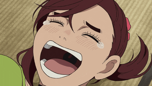 a close up of a girl 's face with her mouth open and tears coming out of her eyes