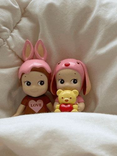 two dolls one with a shirt that says love