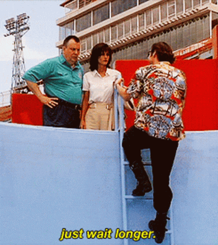 a woman climbs a ladder while a man stands behind her with the words just wait longer