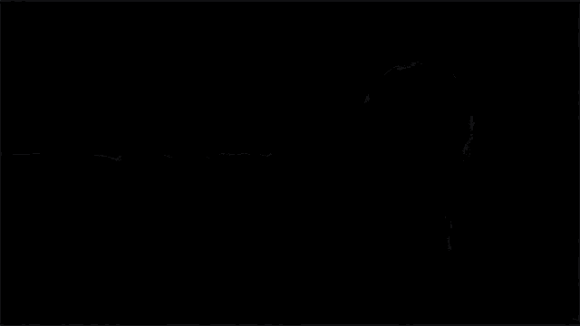 a girl in a school uniform is sitting on a couch in a dark room
