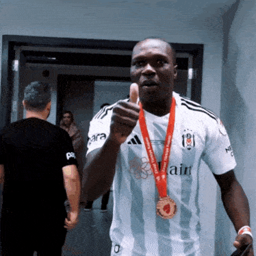 a man with a medal around his neck that says ' izmir türkiye kupası ' on it
