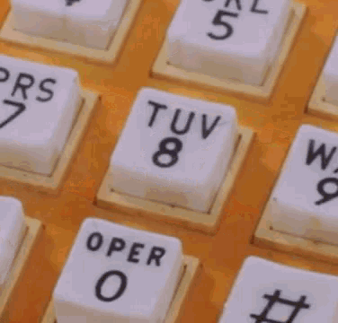 a close up of an orange telephone with the numbers 1 through 9