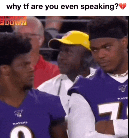 two ravens players are talking to each other in a crowd