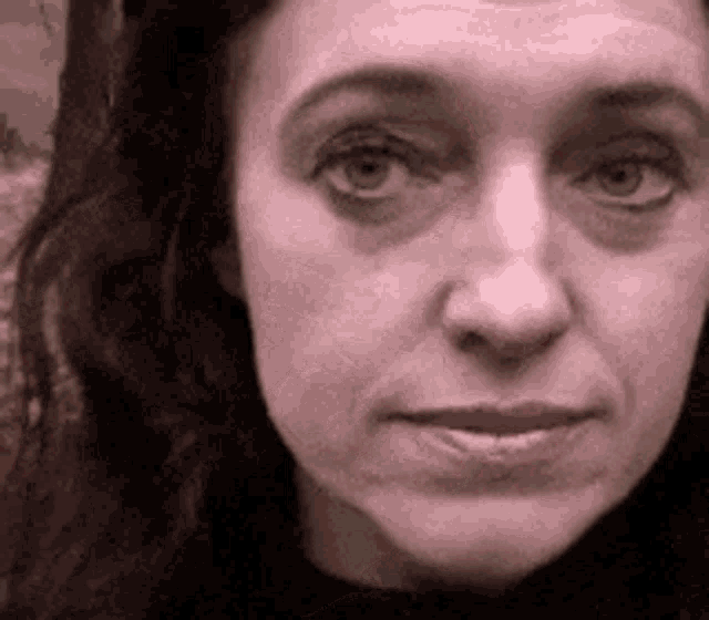 a close up of a woman 's face with a very serious look on her face