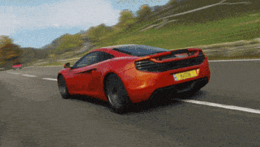 a red sports car is driving down a road with a license plate that says ' s-435s '