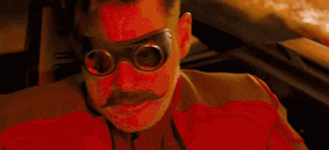 a man with a mustache and goggles is screaming and saying now you 've done it .