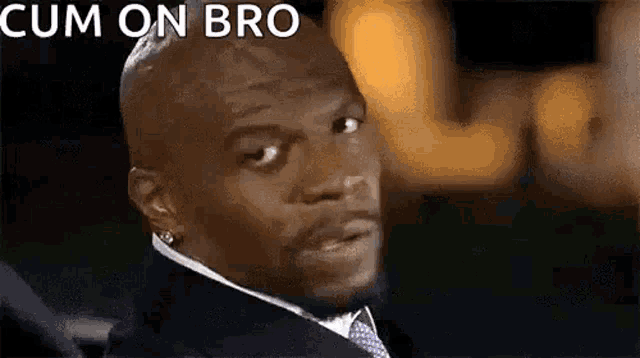 a close up of a man in a suit and tie with the words `` cum on bro '' written on his face .