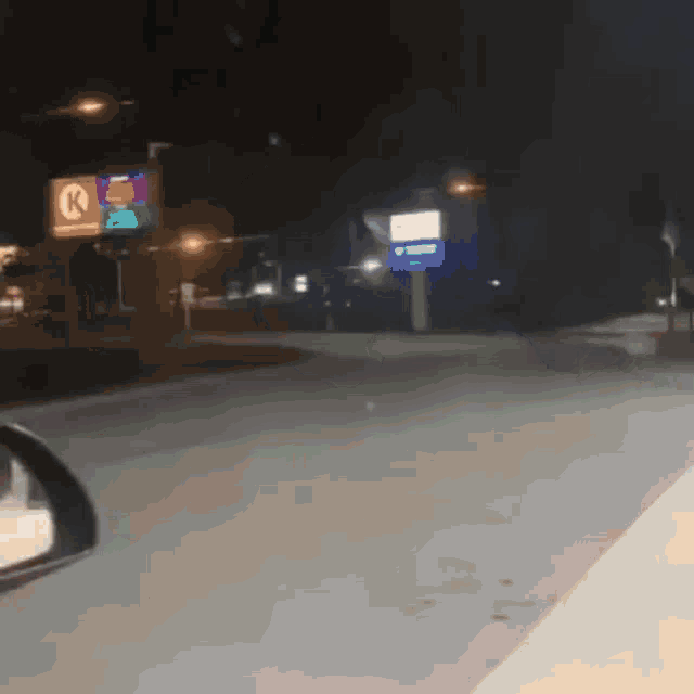 a reflection of a car in a rear view mirror shows a k-mart sign