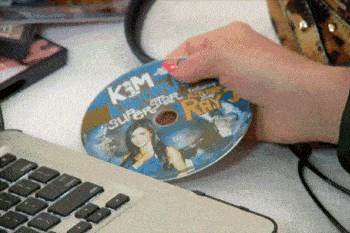 a person is holding a cd that says kim kardashian superstar