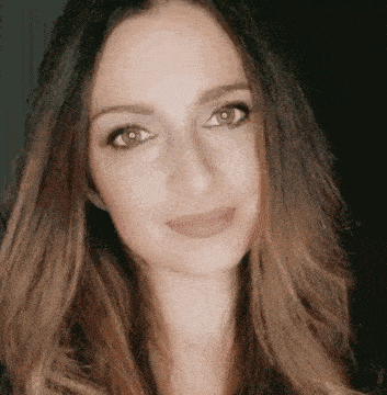 a close up of a woman 's face with a black background .