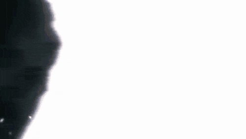 a white object is glowing in the dark against a black background