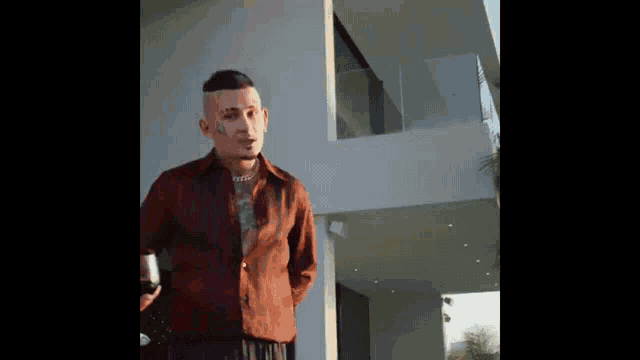 a man in a red shirt is holding a glass of wine while standing in front of a house .