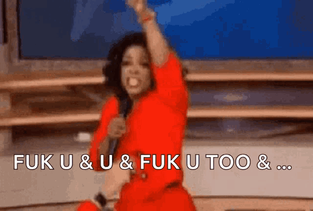 a woman in a red dress is holding a microphone and says fuk u & u & fuk u too