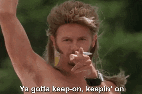 a man with a mullet is smoking a cigarette and saying ya gotta keep on keepin ' on .
