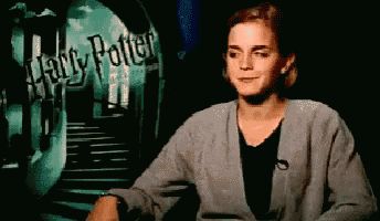 a woman in front of a harry potter poster