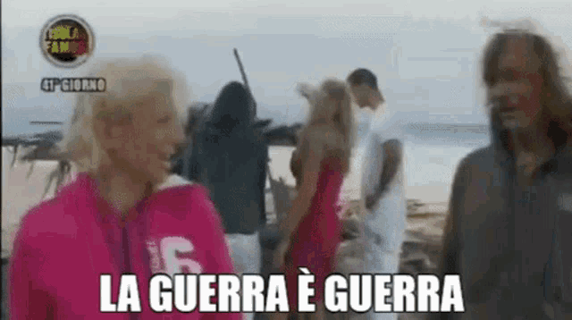 a group of people are standing on a beach with the words la guerra e guerra written on the bottom