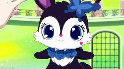 a person petting a black and white bunny with a blue flower on its head