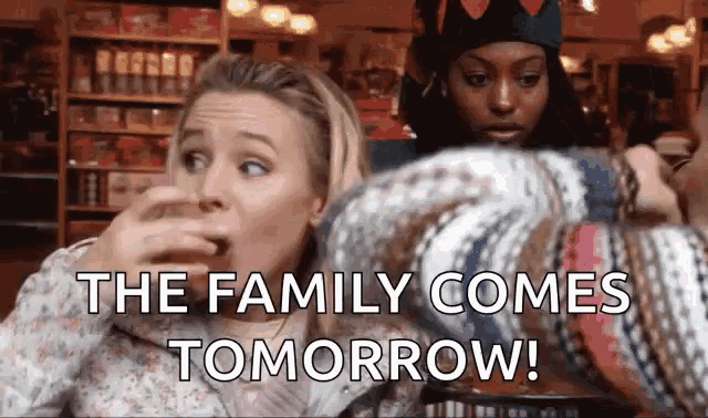 two women are sitting at a table with the words the family comes tomorrow
