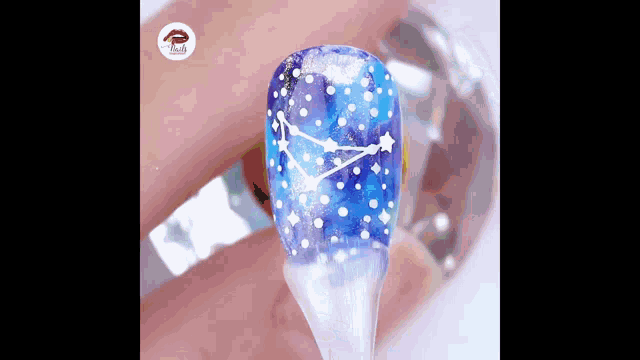 a close up of a person 's nails with a galaxy design on them .