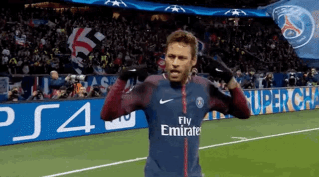 a soccer player wearing a jersey that says fly emirates on it