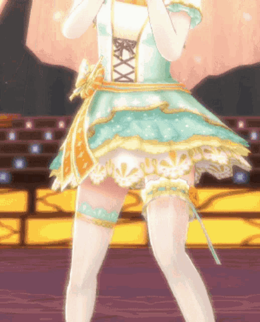 a girl in a green and gold dress is standing in front of a stage