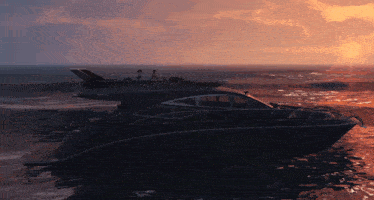 a boat is floating in the ocean with the sun setting in the background