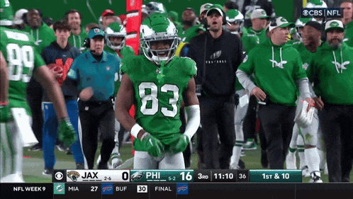 a football player wearing a green jersey with the number 83