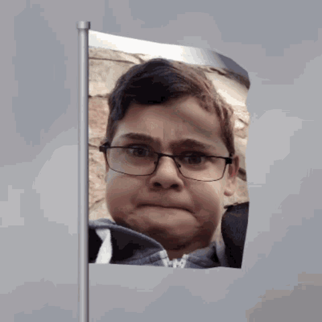 a boy with glasses is making a funny face