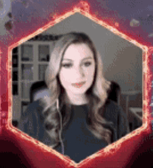 a woman is sitting in a chair with headphones on and a red frame around her .