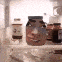 a jar with a face on it is on a shelf in a fridge
