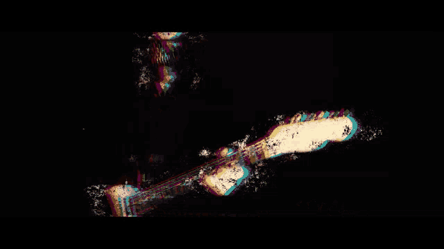 a person is playing a guitar in a dark room with a rainbow of lights coming out of it .