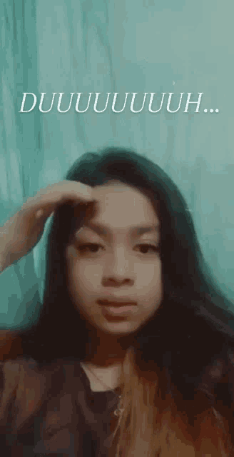 a woman with long hair is making a funny face with the words duuuuuuuuh written above her
