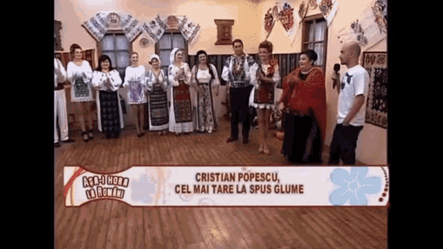 a group of people standing in front of a sign that says " cristian popescu cel mai tare la spus glume "