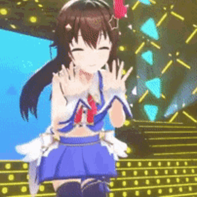 a girl in a blue skirt is standing on a stage with her hands outstretched