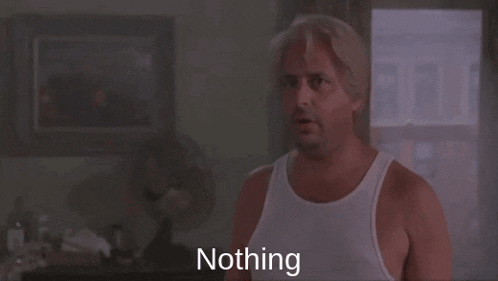 a man in a white tank top says nothing in front of a fan