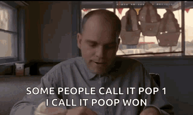 a bald man is sitting in a diner and says some people call it pop 1