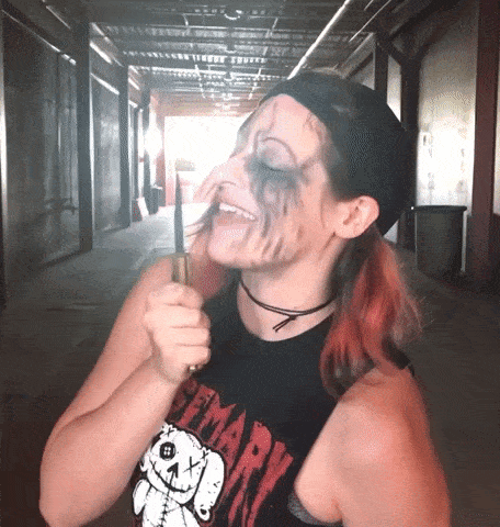 a woman wearing a shirt that says primary holds a knife