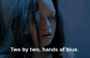 a close up of a woman 's face with the words two by two hands of blue