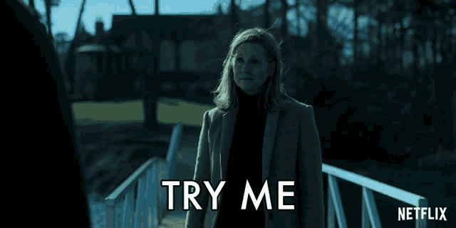 a woman standing on a bridge with the words try me written on the bottom