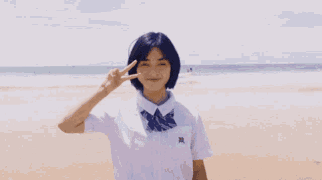 a girl wearing a white shirt with the letter x on the sleeve