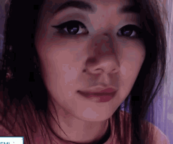 a close up of a woman 's face with the word emi on the bottom left