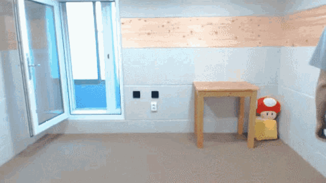 a room with a table and a stuffed mushroom in the corner
